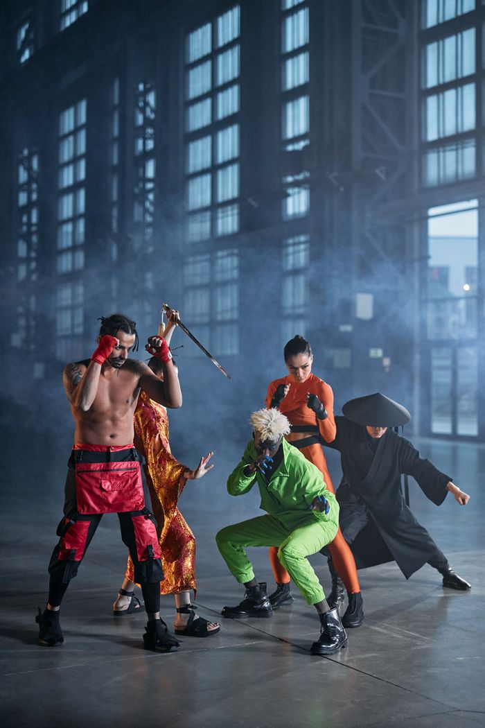gallery-05 Vibrant cosplay group posing in an industrial hall, embodying fictional characters.